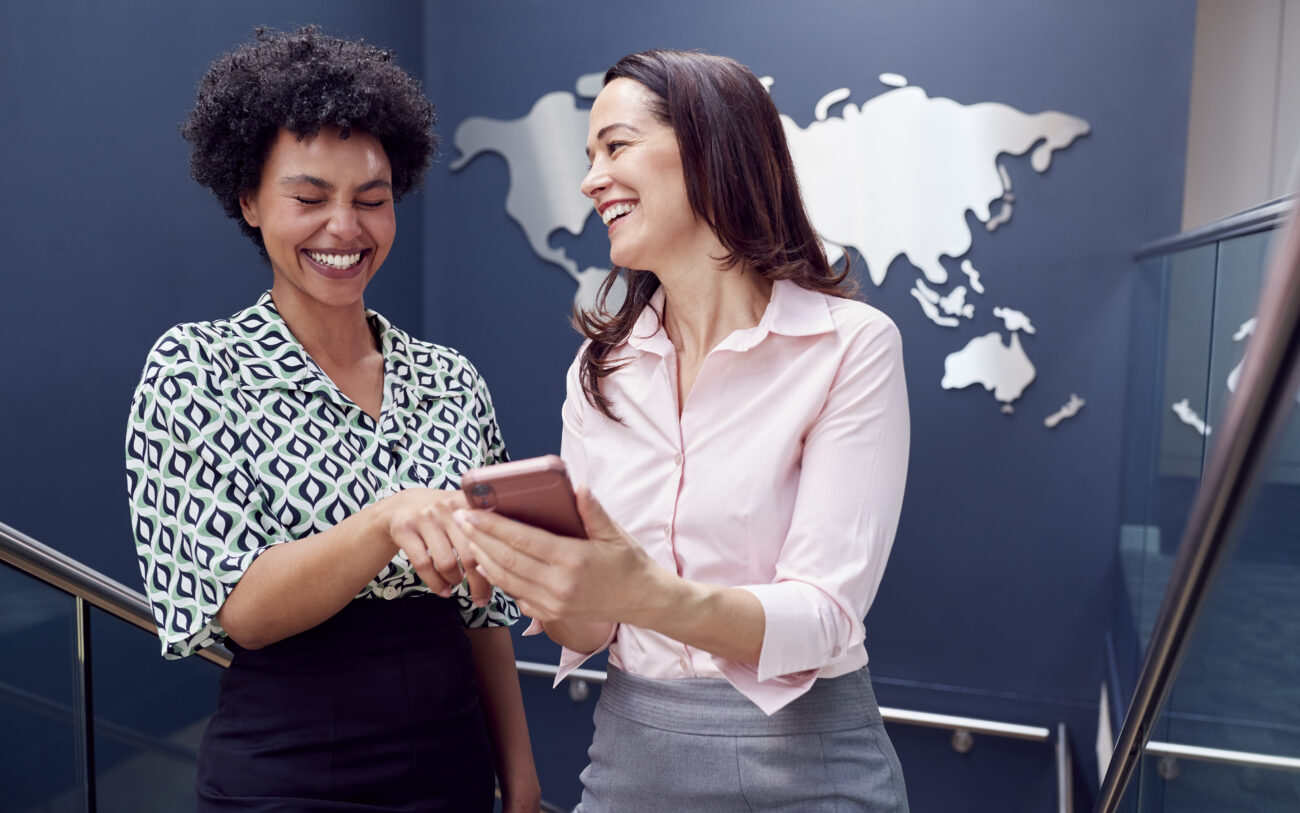 female colleagues looking at mobile phone on stair 2024 10 19 05 28 36 utc
